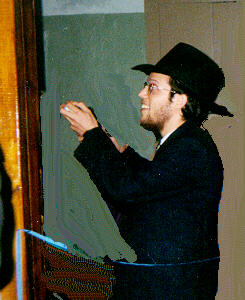 Samara Rabbi Shlomo Deutch nails the Mezuzah to Jewish Library Door